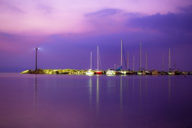 View of a yacht harbor at night. Long exposure shot.Beautiful beach sunset clipart