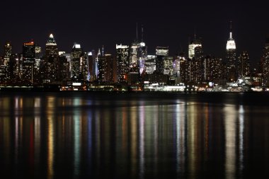 Midtown (West Side) Manhattan at night seen from Weehawken, NJ. clipart