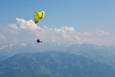 Paragliding in mountains clipart