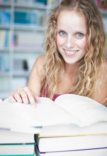 Estudiante universitaria bastante femenina en una biblioteca (DOF poco profundo; color t — Foto de Stock