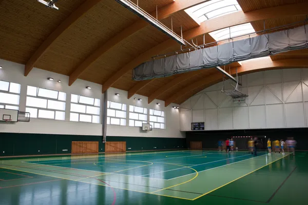 Interior of a modern multifunctional gymnasium with young — Stock Photo, Image