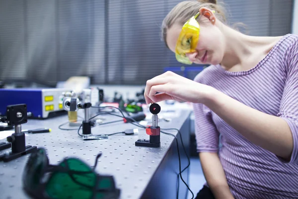 Female scientist doing research in a quantum optics lab (color t — Stock Photo, Image
