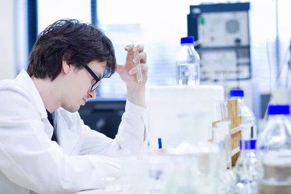 Giovane ricercatore di sesso maschile che svolge ricerche scientifiche in un laboratorio chimico — Foto Stock