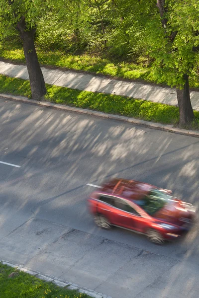 Speeding concept - Cars moving fast on a road on a lovely sunny — Stock Photo, Image