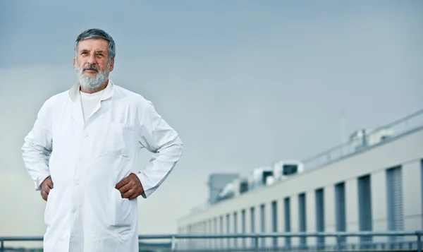 Renowned scientist/doctor standing on the roof of the research c — Stock Photo, Image