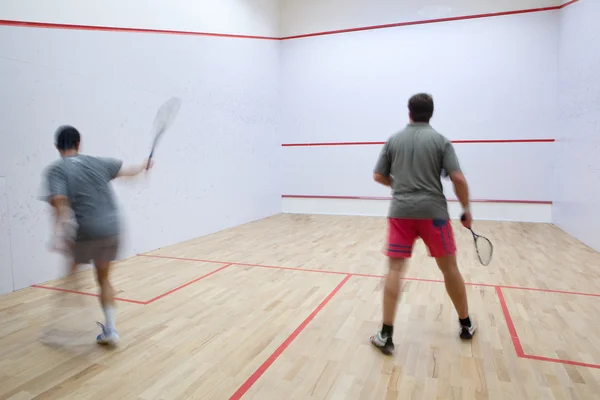 Squash oyuncular eylem bir squash kortu (hareket bulanık görüntü üzerinde — Stok fotoğraf