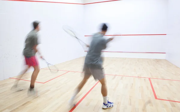 Squash players in action on a squash court (motion blurred image — Stock Photo, Image