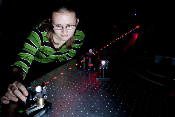 Female scientist doing research in a quantum optics lab