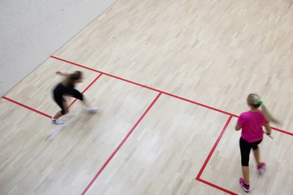 Deux joueuses de squash en action rapide sur un court de squash (moti — Photo