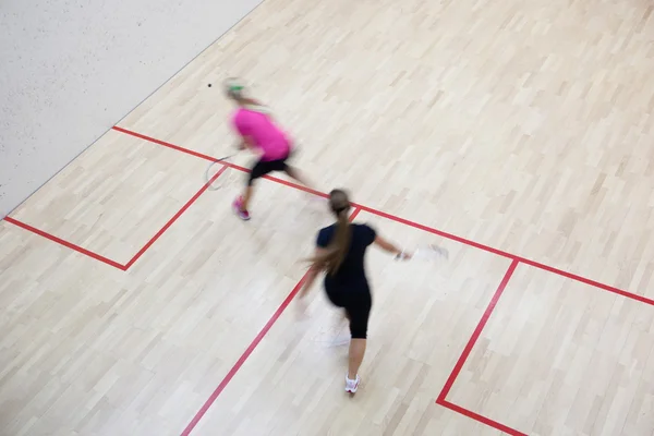 stock image Two female squash players in fast action on a squash court (moti