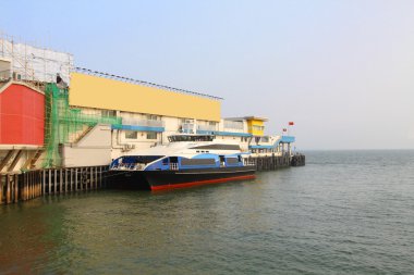 Ferry pier with ship to Macau clipart