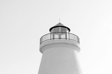 White light house in blue sky clipart