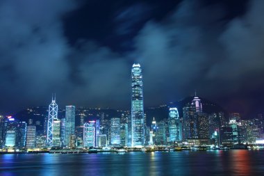 Hong Kong skyline in cyber toned at night clipart