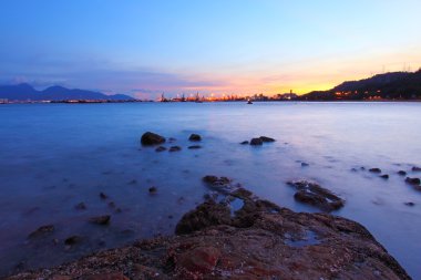 Sunset along the coast in Hong Kong clipart