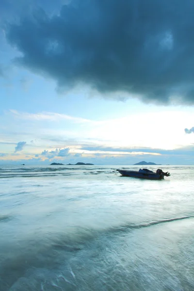 stock image A boat in the sea with thunderstorm coming