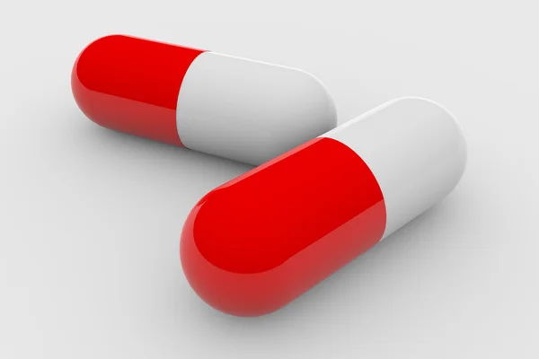Two red and white pills — Stock Photo, Image