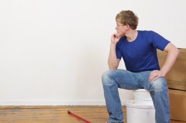 Young man painting a wall clipart