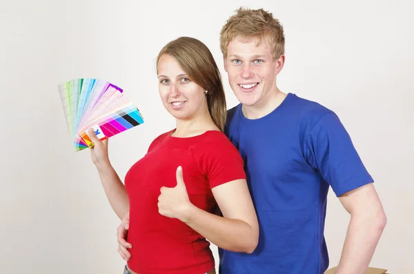 Giovane coppia guardando fuori il colore della parete — Foto Stock