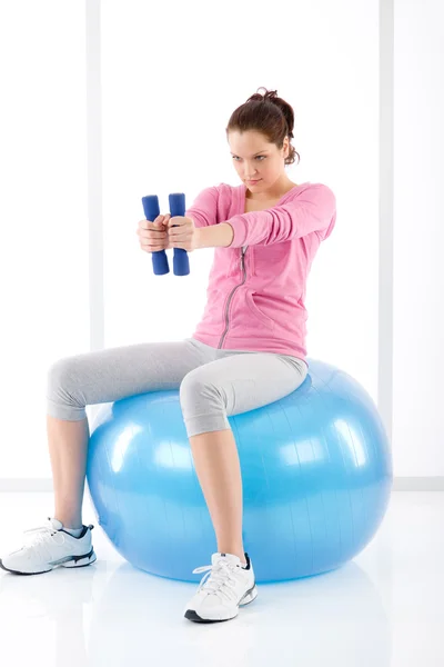 Fitness woman exercise dumbbell ball gym — Stock Photo, Image