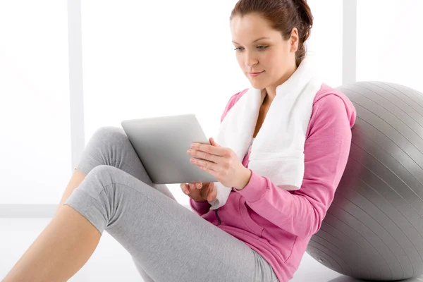 Woman touch screen computer fitness outfit — Stock Photo, Image