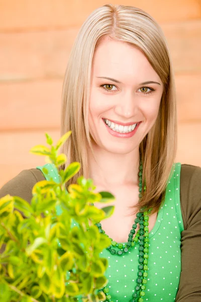 Portrait happy woman hold green plant spring — Stock Photo, Image
