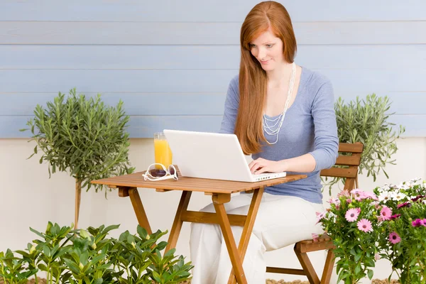 Summer terrace redhead woman with laptop — Stock Photo, Image