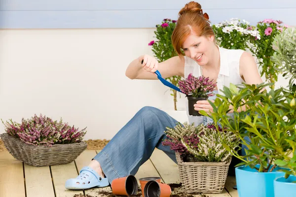 Summer garden terrace redhead woman potted flower — Stock Photo, Image