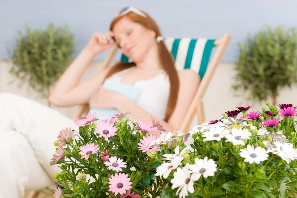 Summer terrace red hair woman relax in deckchair — Stock Photo, Image