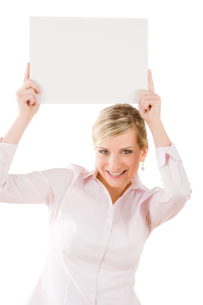 Happy businesswoman holding up empty banner — Stock Photo, Image