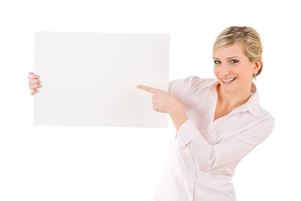 Businesswoman pointing aside at white banner — Stock Photo, Image