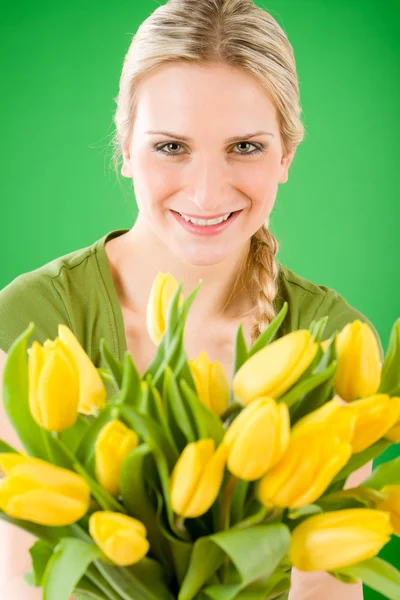 Young woman hold yellow tulips flower — Stock Photo, Image