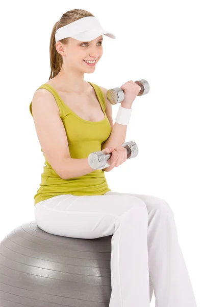 Fitness teenager woman with dumbbell sit on ball — Stock Photo, Image