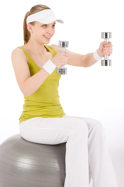 Fitness genç kadın dumbbell ile topa otur — Stok fotoğraf