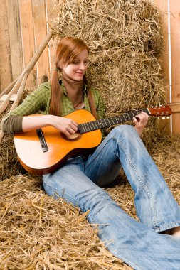 Genç ülke kadın ahırda gitar çalmak