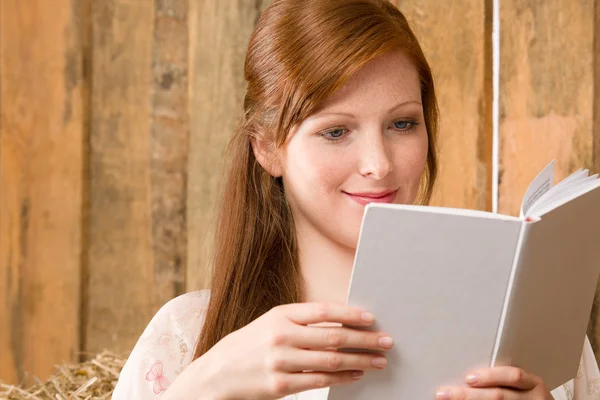 Young romantic woman in barn reading book — Stock Photo, Image