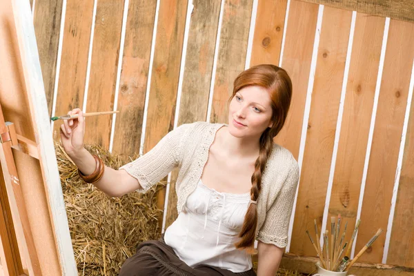 stock image Red-hair romantic woman painting in barn