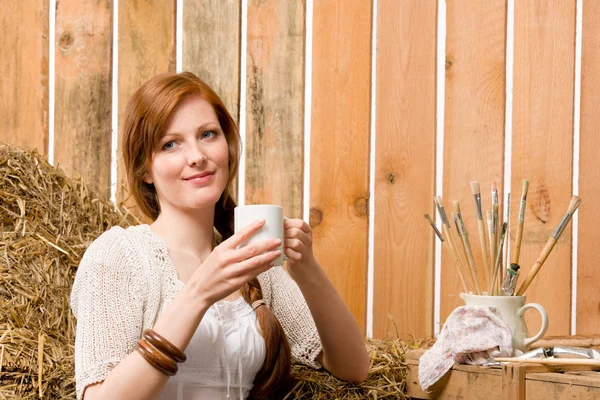 Young romantic woman in barn holding cup — Stock Photo, Image