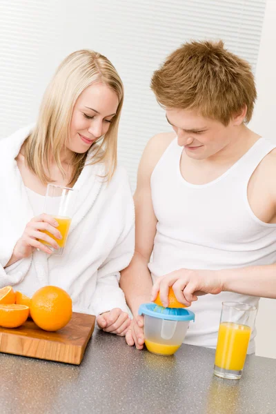 Pequeno-almoço casal feliz fazer manhã suco de laranja — Fotografia de Stock