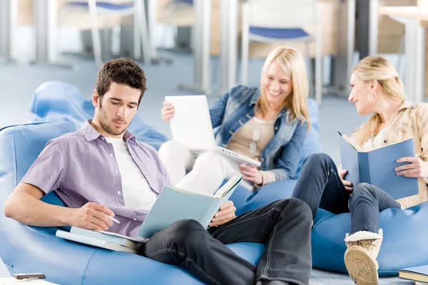 Group of high-school students with books sitting Royalty Free Stock Images