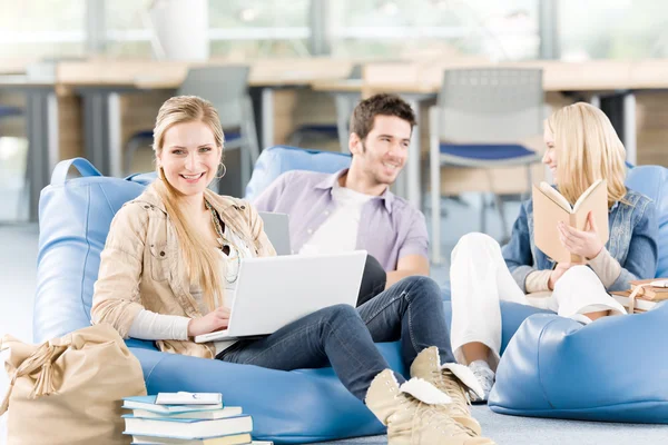 Group of high-school students with books sitting Stock Photo