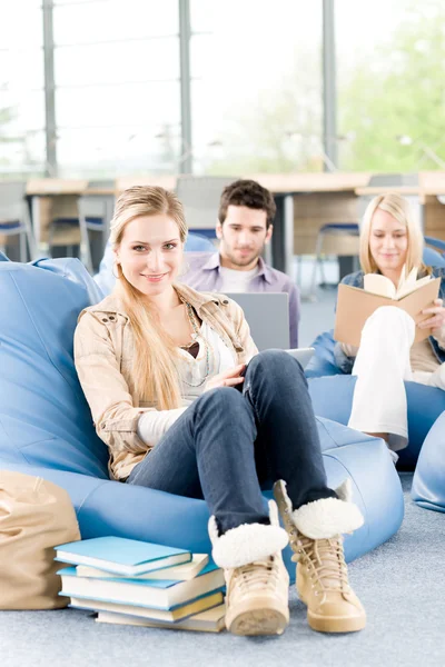 Group of high-school students with books sitting Stock Picture