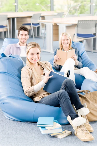 Group of high-school students with books sitting Royalty Free Stock Photos