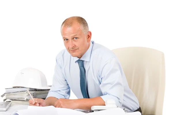 Professional architect with blueprint behind table — Stock Photo, Image