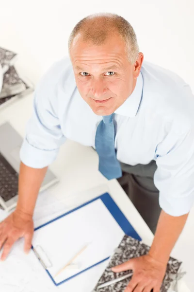 Senior man standing above office table — Stock Photo, Image