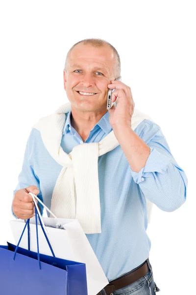 Kıdemli mutlu bir adam alışveriş torbaları holding — Stok fotoğraf