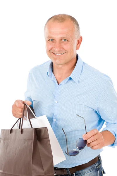 Érett smilling ember tartsa bevásárló táskák — Stock Fotó