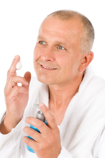 Male cosmetics - senior mature man wash face — Stock Photo, Image