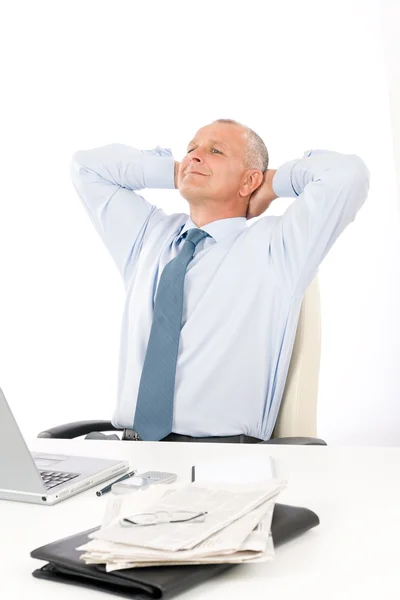 Happy businessman relaxing in office behind desk — Stock Photo, Image