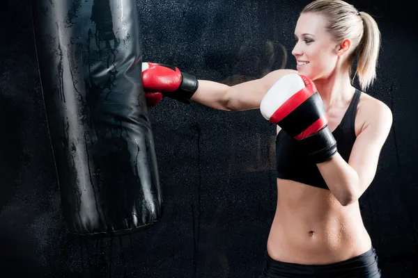 Boxing training woman punching bag in gym — Stock Photo, Image