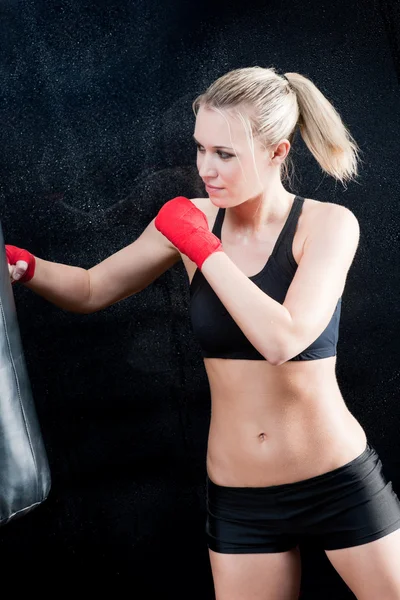 Boxing training blond woman sparring punching bag — Stock Photo, Image